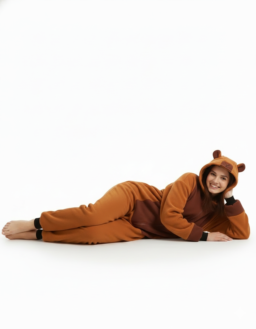 Person wearing a brown bear onesie on a white background