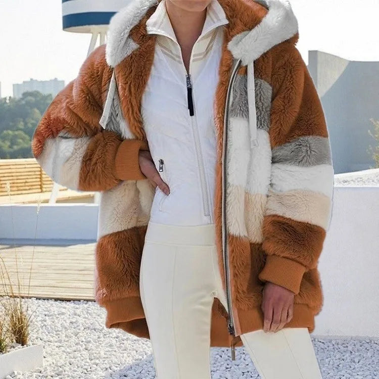 Person wearing a multicolored fur coat with a white interior on a rooftop.