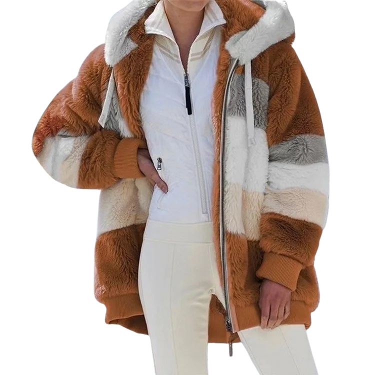 Person wearing a brown and white striped faux fur coat on a white background