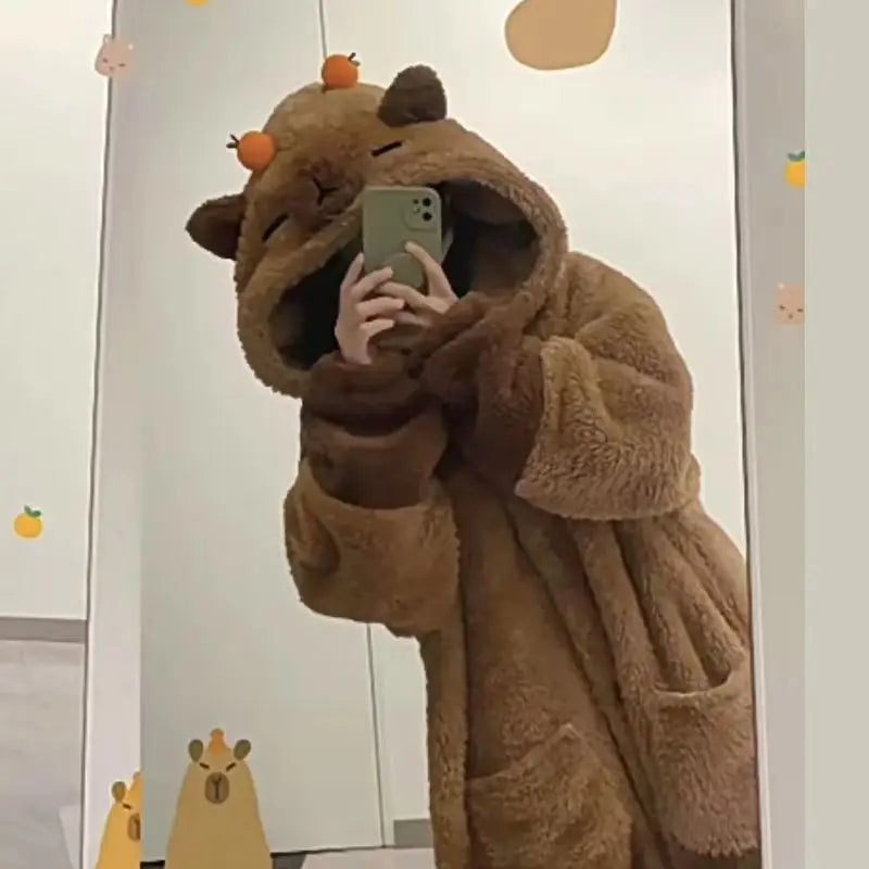 Person wearing a brown bear-themed robe taking a mirror selfie.