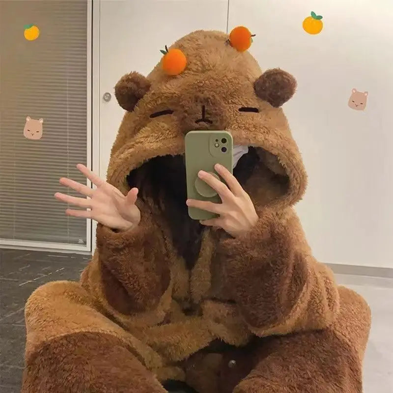 Person wearing a brown bear onesie taking a mirror selfie.