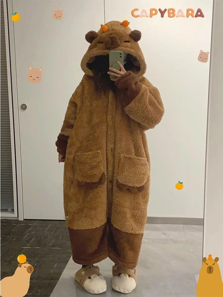 Person wearing a brown capybara onesie taking a mirror selfie.