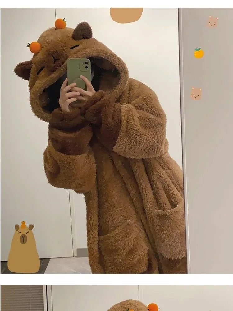 Person wearing a brown bear-themed robe taking a mirror selfie.