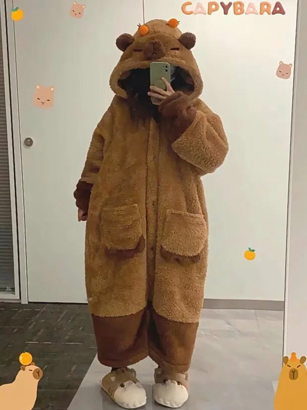 Person wearing a brown capybara onesie taking a mirror selfie.