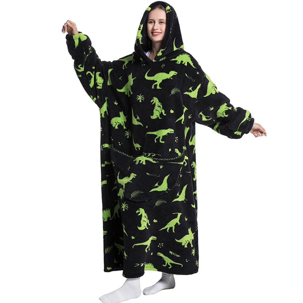 Person wearing a black hoodie with green dinosaur patterns on a white background