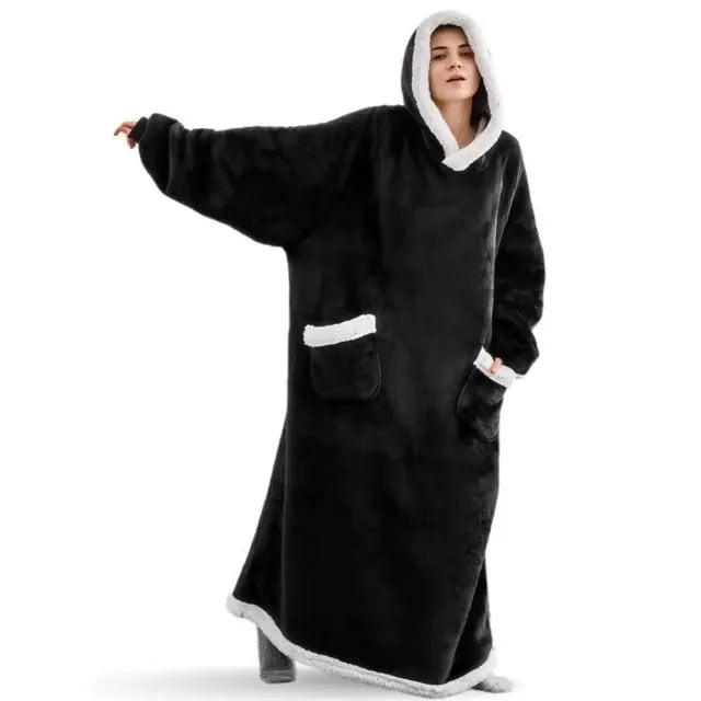 Person wearing a black and white hooded blanket on a white background