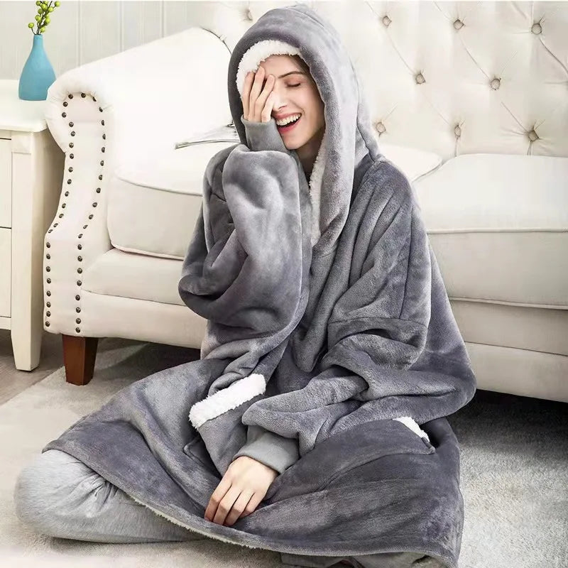 Person wrapped in a gray hoodie with sherpa lining on a couch