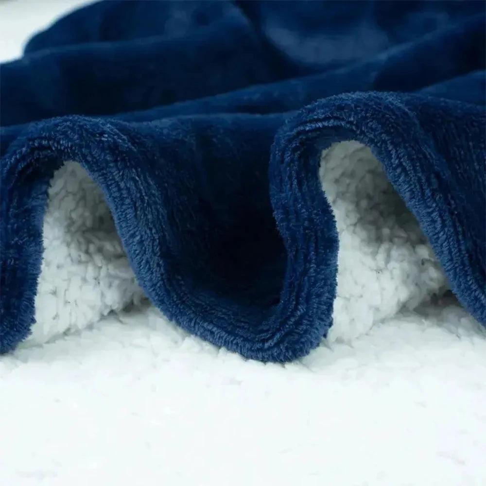 Close-up of a blue textured blanket with white lining