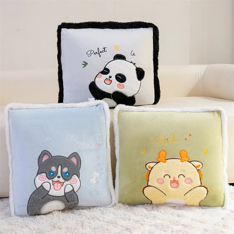 Three plush cushions with cartoon designs on a light-colored couch.