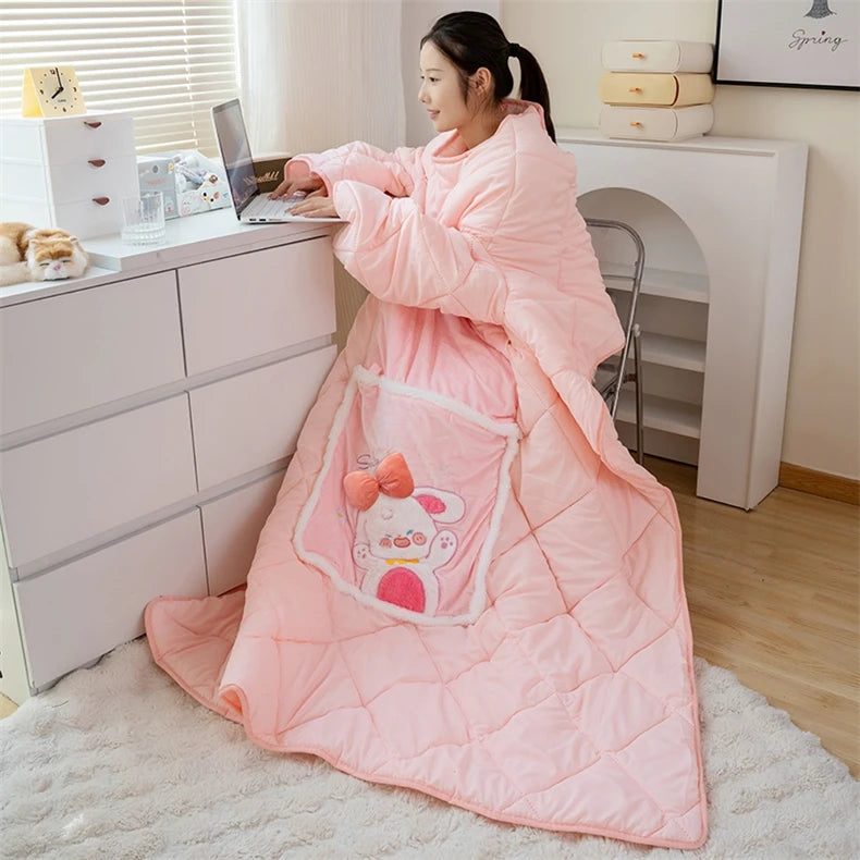 Person wearing a pink cartoon-themed blanket in a home office setting