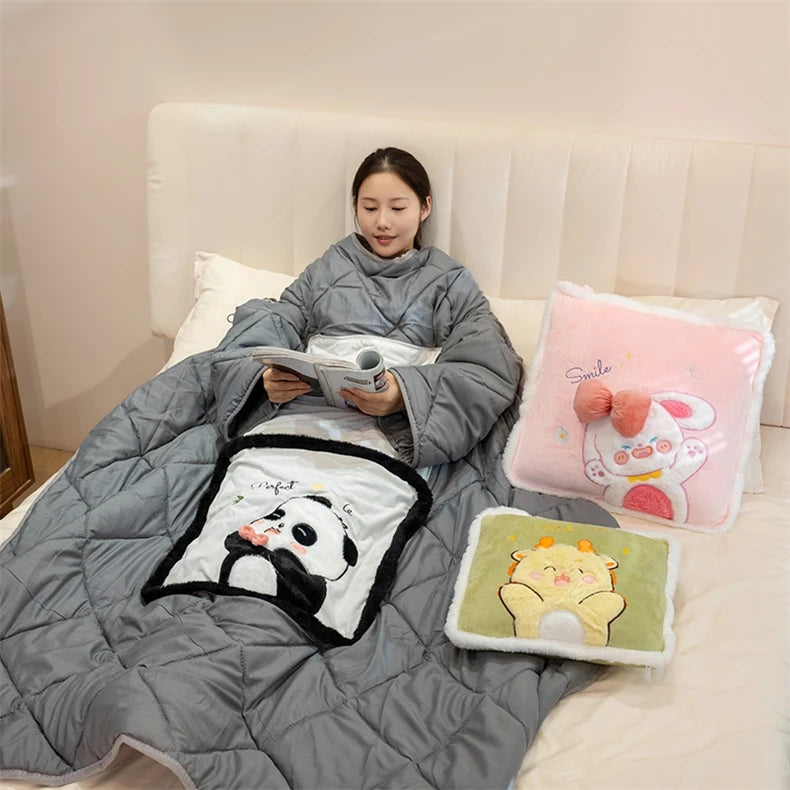 Person wrapped in a gray blanket with cartoon designs on a bed.
