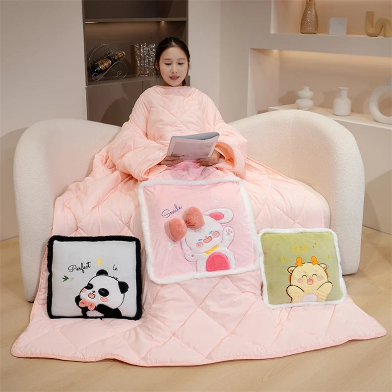 Person sitting on a couch under a pink blanket with cartoon pillows