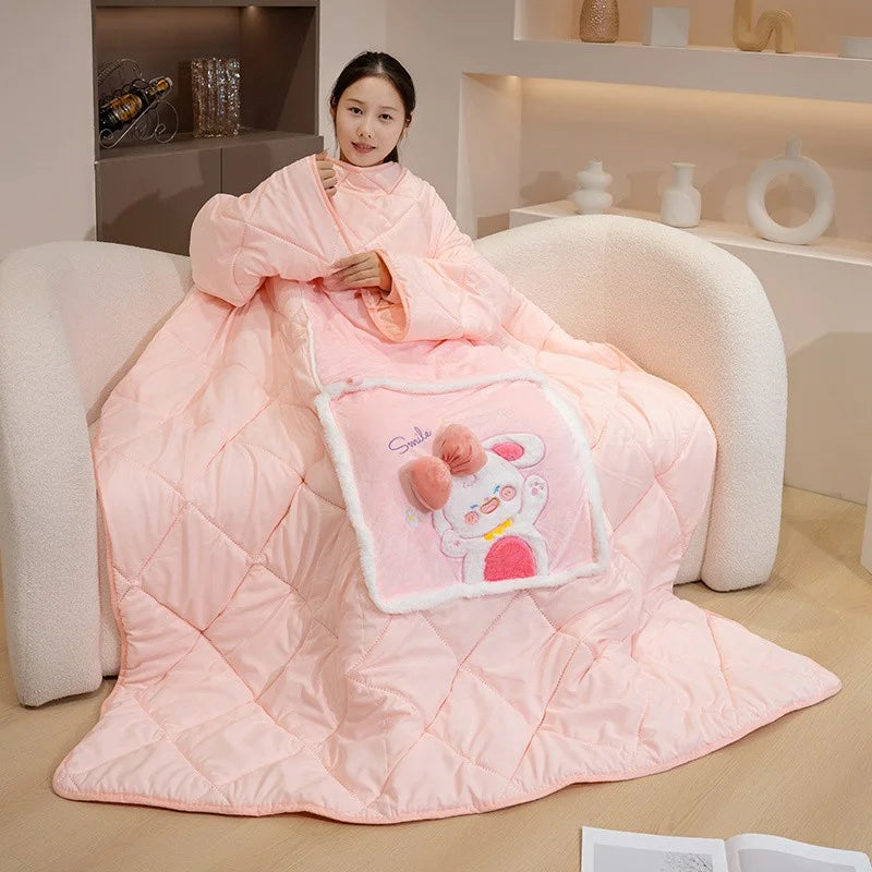 Person wrapped in a pink cartoon-themed blanket sitting on a couch.